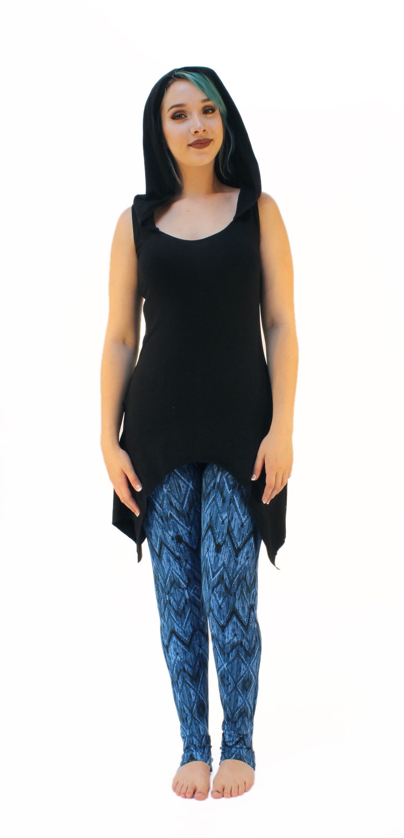 May include: A black sleeveless top with a hood and a high-low hemline. The top is paired with blue and black patterned leggings.