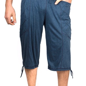 May include: Blue cotton pants with a drawstring waist and side pockets. The pants have a relaxed fit and are cropped at the knee.