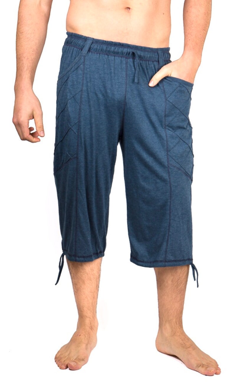 May include: Blue cotton pants with a drawstring waist and side pockets. The pants have a relaxed fit and are cropped at the knee.