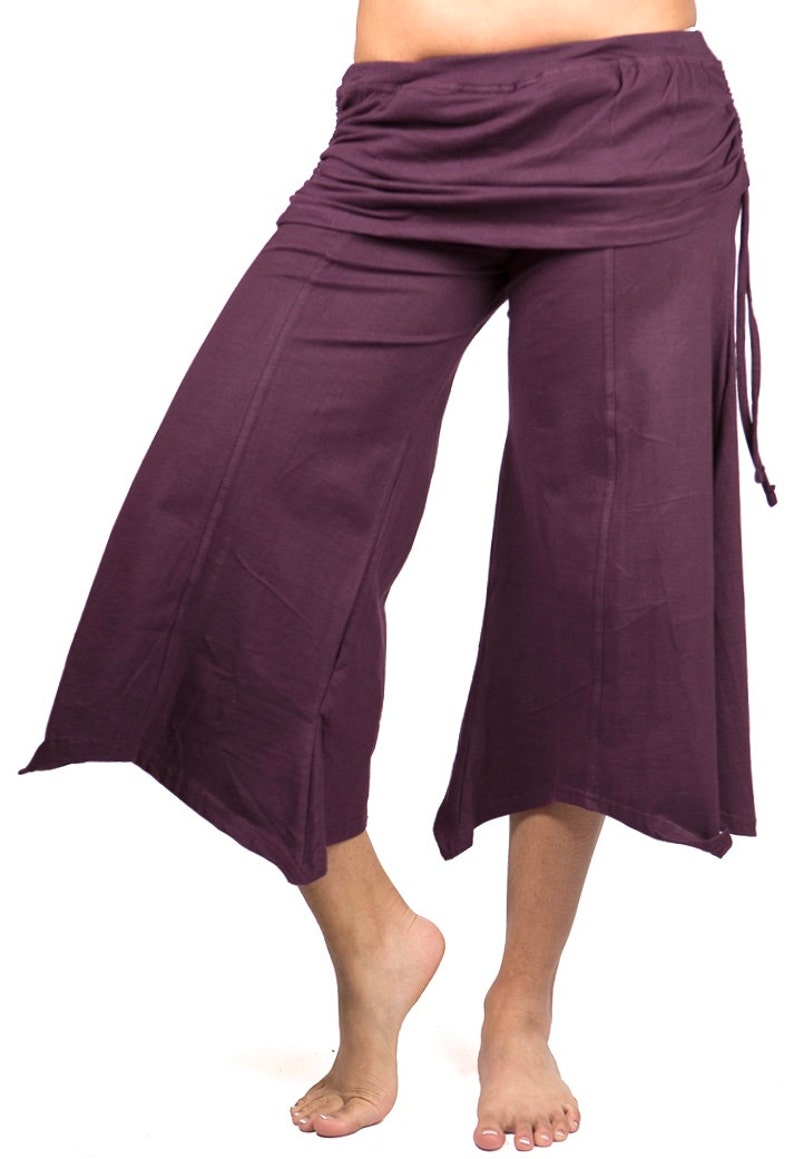 May include: A pair of purple wide-leg pants with a gathered waistband and a tie at the side.