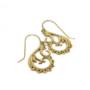 May include: A pair of gold filigree dangle earrings with a delicate, intricate design. The earrings are made of metal and have a hook closure.