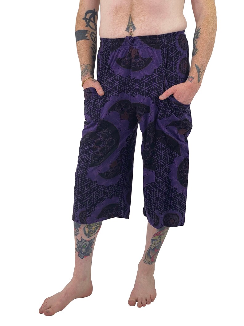 May include: Purple printed pants with a geometric pattern and a drawstring waist.