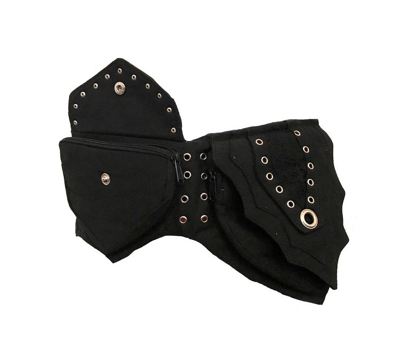 May include: Black canvas belt with multiple pockets and decorative eyelets. The belt has a zippered pocket and a flap with a snap closure.