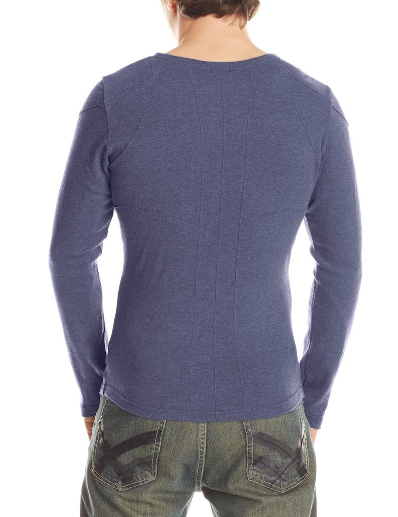 May include: A long-sleeved, blue shirt with a crew neck and vertical stitching down the back. The shirt is paired with blue jeans with a black design on the back pockets. The model is facing away from the camera.