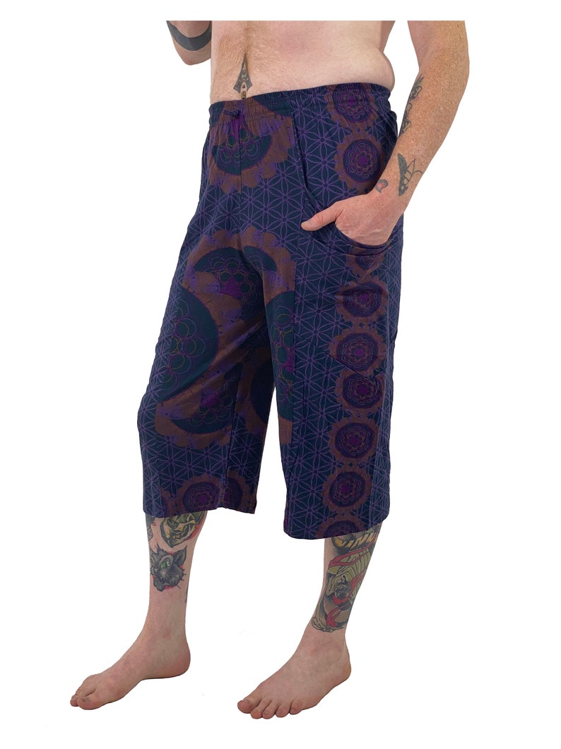 May include: Purple and brown patterned cropped pants with an elastic waistband and a pocket on the right side.