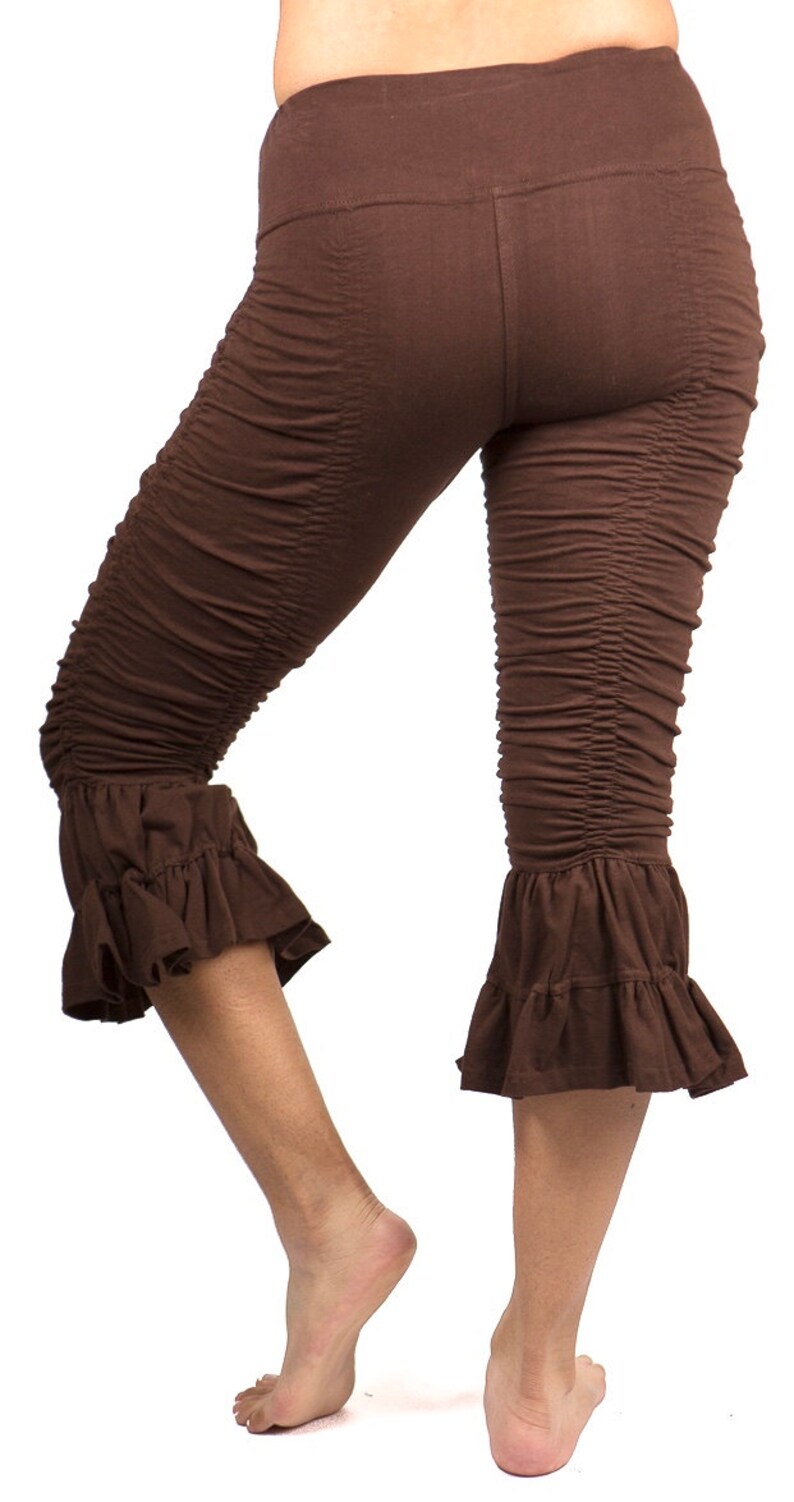 May include: Brown capri leggings with a ruffled hem. The leggings are made of a soft, stretchy fabric and have a comfortable fit.