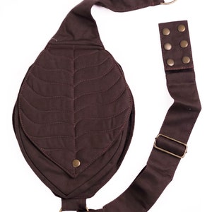 May include: A brown quilted leaf-shaped crossbody bag with a long adjustable strap and metal hardware.