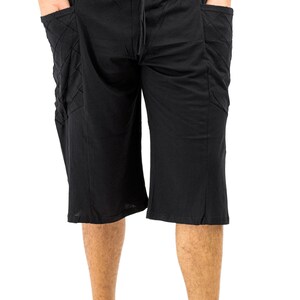 May include: Black, knee-length shorts with a drawstring waist and two large, quilted pockets on the sides.