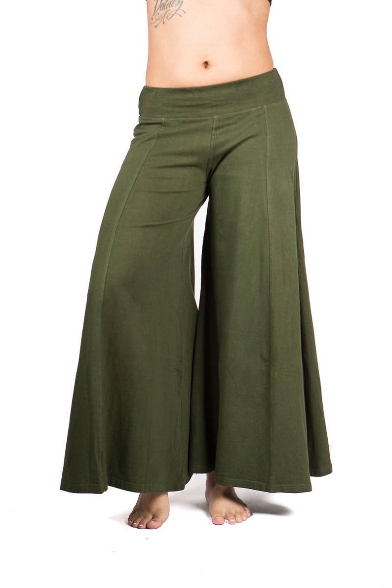 May include: A pair of wide-legged, olive green pants with a relaxed fit. The pants have a simple design and a comfortable look.
