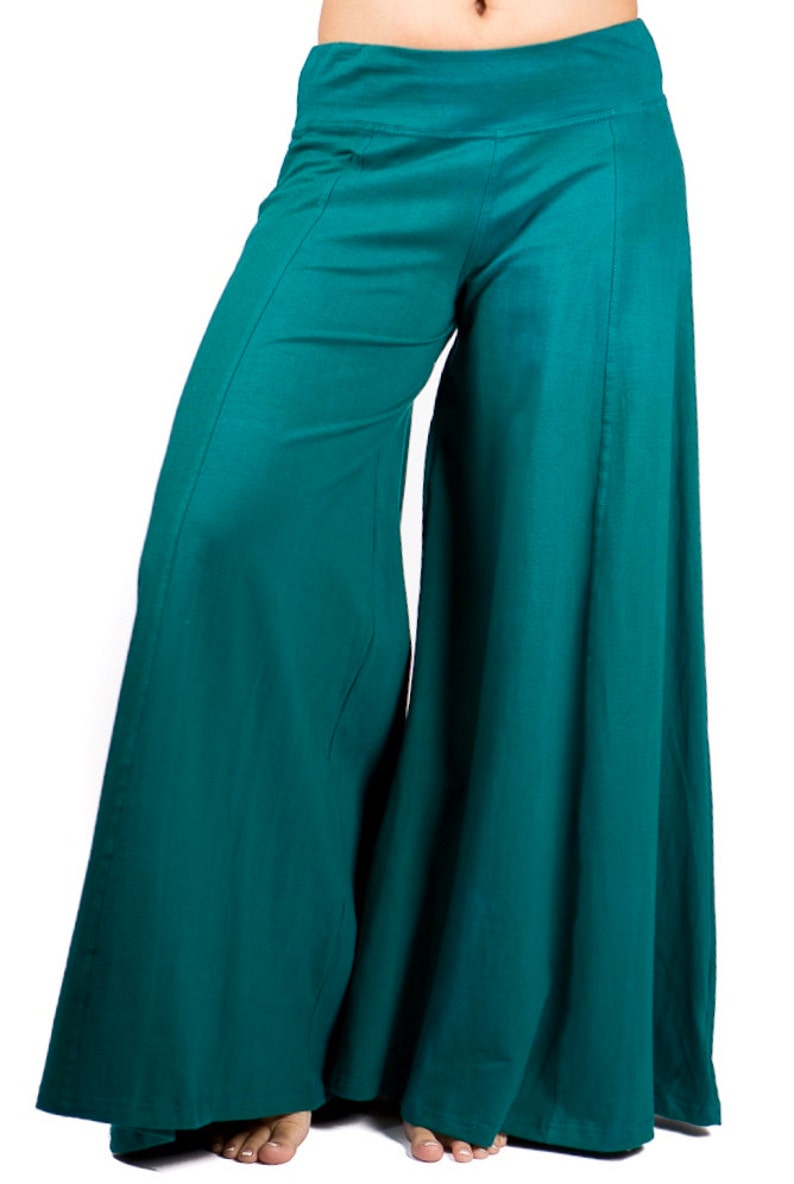 May include: Teal wide-leg pants with a high waist and a flowing silhouette.
