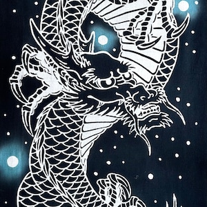 May include: A white dragon illustration on a dark blue background. The dragon is depicted vertically, with detailed scales and a celestial theme. Small white dots and orbs add to the design.