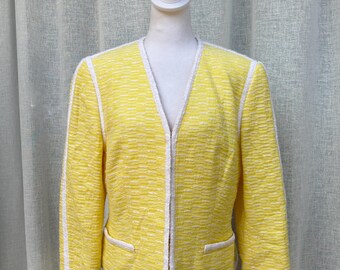 May include: A yellow blazer with white trim. The blazer has a zipper closure and pockets.