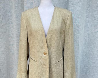 May include: A light beige blazer with a textured weave, displayed on a white mannequin. The blazer has a V-neck, long sleeves, and a single button closure. The pockets are outlined with a darker thread.
