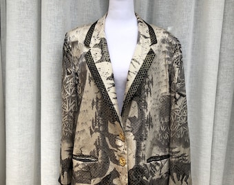 May include: A beige blazer with a black and white animal print design. The blazer has a black trim and gold buttons.