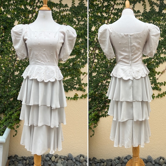 Vintage light grey polyester and rayon tiered peplum dress with faux pearl embellishment made by Michael Maiello for Pat Richards