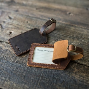 May include: Two leather luggage tags. One is brown with the name "KEVIN" embossed on it. The other is brown and tan with a space for writing "Owner Information".