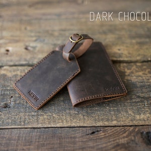 May include: Dark chocolate brown leather luggage tag and passport holder set with the name "Kevin" embossed on each piece.