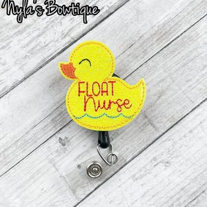 May include: Yellow rubber ducky with the text "FLOAT NURSE" on it. The ducky is attached to a black retractable badge reel.