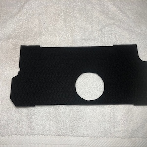 May include: Black felt cutout with a circular hole in the center. The cutout is shaped like a rectangle with rounded corners.
