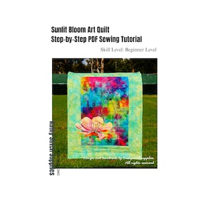 May include: A vibrant art quilt with a floral design. The quilt showcases a mix of pink, blue, and green hues. The text "Sunlit Bloom Art Quilt" and "Step-by-Step PDF Sewing Tutorial" are displayed on the image.
