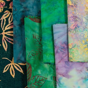 May include: Assortment of fabric swatches in various shades of green, blue, and purple with leaf and floral patterns.