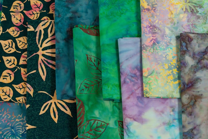 May include: Assortment of fabric swatches in various shades of green, blue, and purple with leaf and floral patterns.