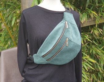 Multi-pocket fanny pack in green corduroy.