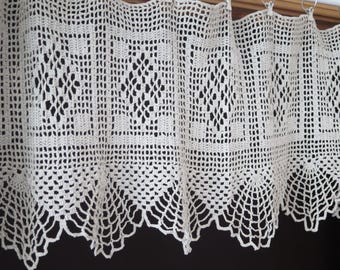 May include: White crocheted valance with a scalloped edge and a repeating diamond pattern.