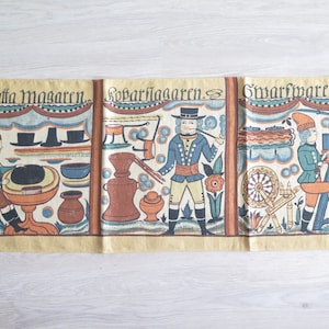 May include: A vintage textile panel featuring three illustrated scenes with figures in period clothing. The artwork is in a folk art style, with a muted color palette of beige, blue, brown, and orange. The panel has text at the top of each scene.