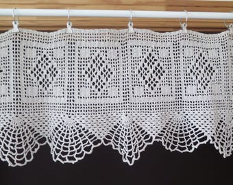 May include: White crocheted valance with a scalloped bottom edge and a repeating geometric pattern.