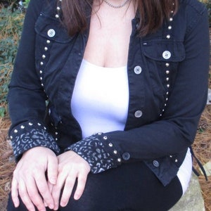 Black shirt jacket with silver spikes and studs and hand painted cuffs in a women&#39;s size medium.