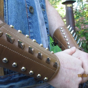 1 pair tan leather Gauntlets with chrome dragon spikes and studs.  mens size