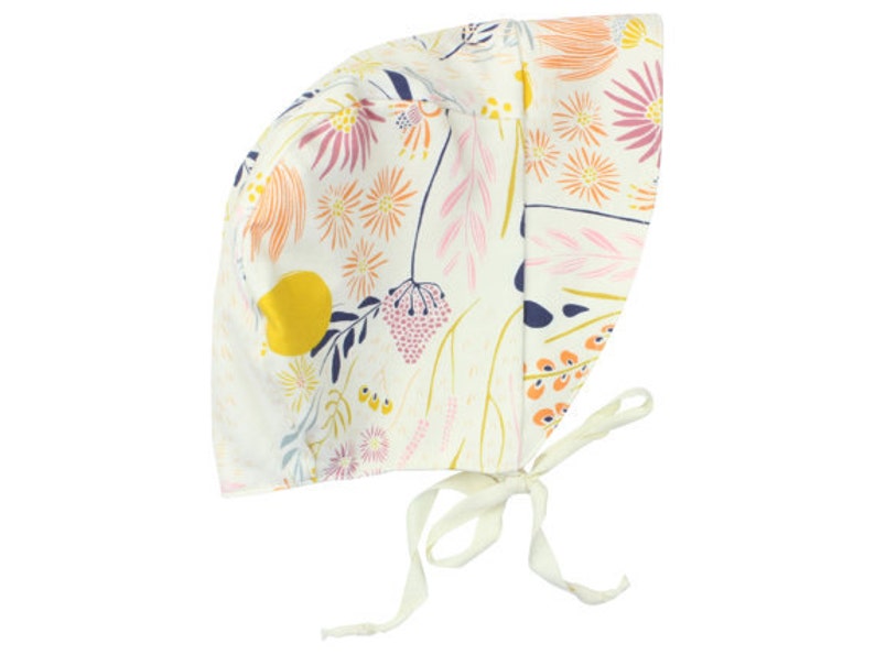 May include: A white baby bonnet with a floral print featuring pink, yellow, orange, and blue flowers. The bonnet has a tie at the back.
