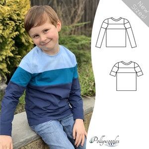 May include: A boy wearing a blue, teal and navy striped long-sleeved shirt. The shirt has a crew neck and is made of a soft, comfortable fabric. The shirt is available in a variety of sizes. New Sizes! Pollywoggles.