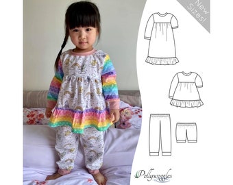 May include: A sewing pattern for a girl's pajamas with a rainbow print. The pattern includes a long-sleeved top with a ruffle hem, pants, and a shorter top with a ruffle hem. The pattern is called "Pollywoggles" and includes "New Sizes!" text.