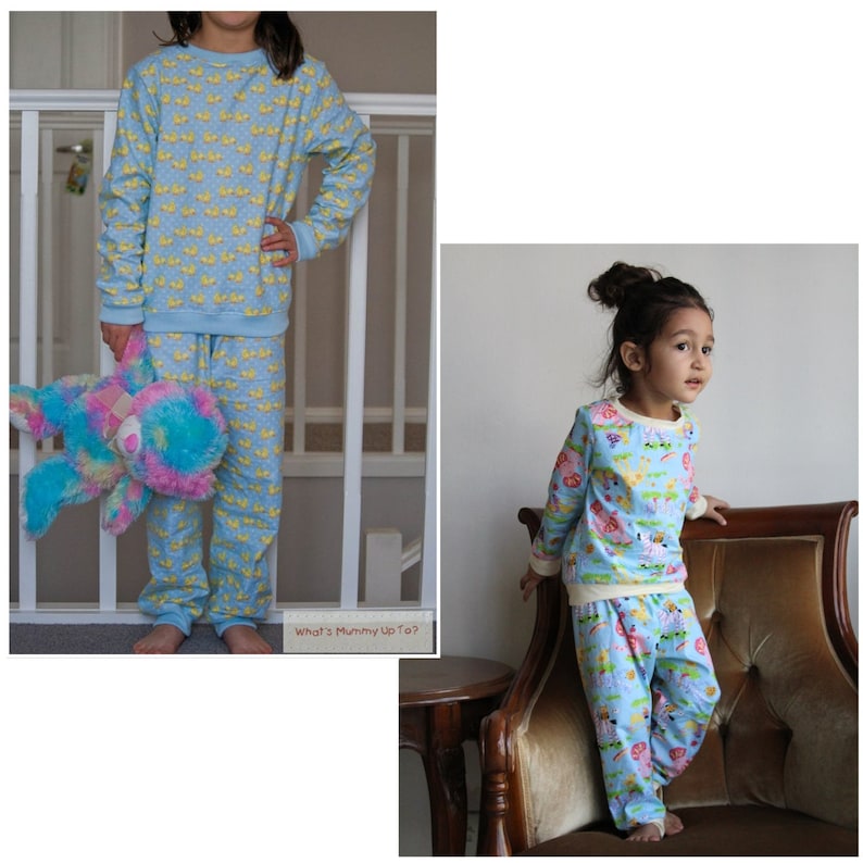 May include: Two children wearing blue pajamas with different patterns. The pajamas have long sleeves and long pants. The child on the left is holding a stuffed animal. The child on the right is standing next to a brown armchair. The text "What's Mummy Up To?" is visible in the bottom right corner of the image.