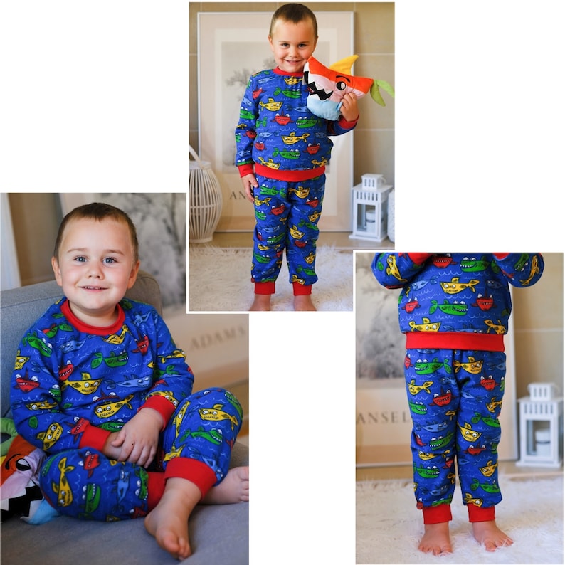 May include: A blue and red pajama set for a child featuring a print of yellow submarines with smiling faces on a blue background.