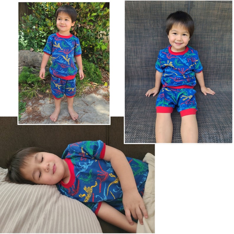 May include: A blue and red pajama set with a dinosaur print. The pajamas feature a short-sleeved shirt and shorts. The boy is wearing the pajamas in three different poses.
