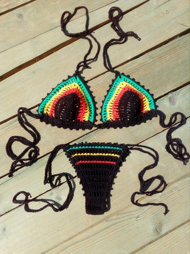 May include: A black crochet bikini with green, yellow, and red accents. The bikini top and bottom have adjustable ties.