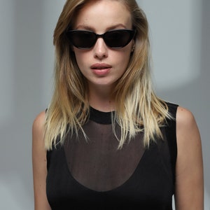 Trendy fashion unique black cat eye sunglasses women with polarized lenses UV400.