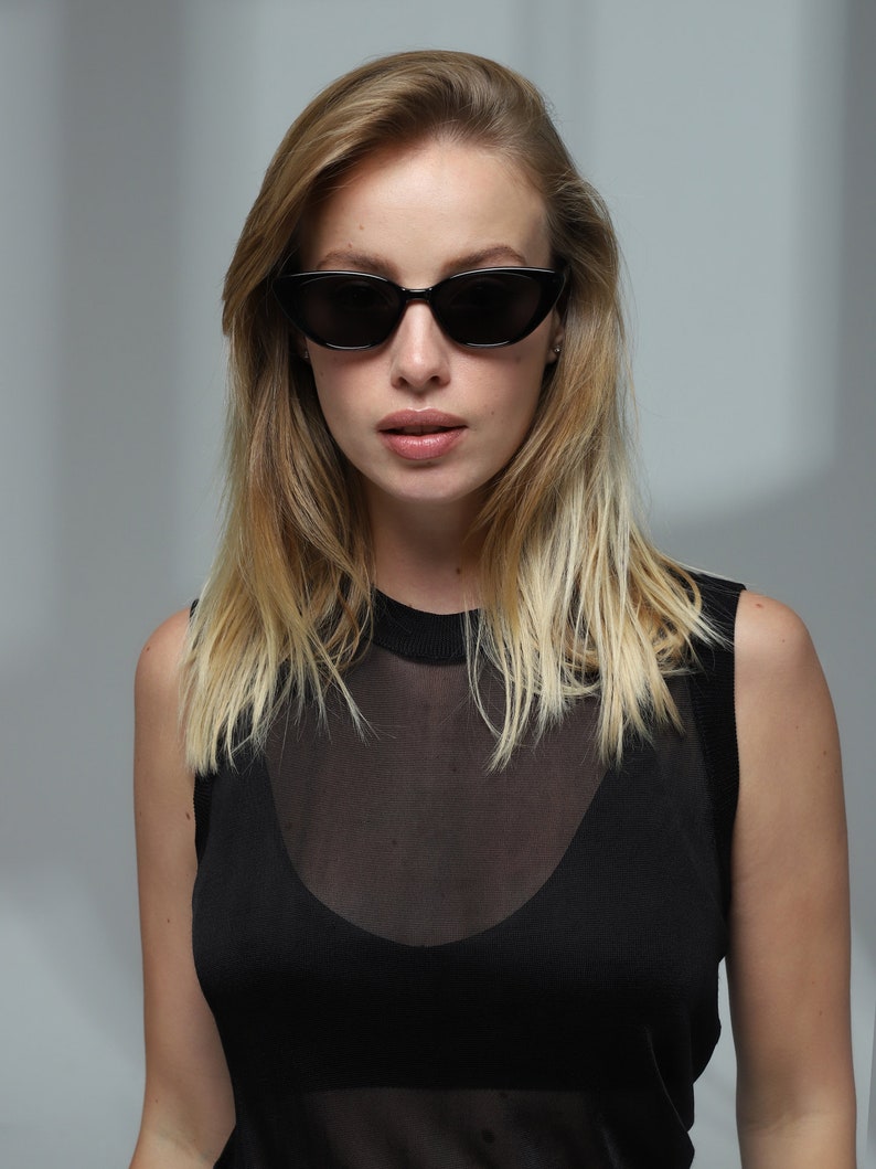Trendy fashion unique black cat eye sunglasses women with polarized lenses UV400.