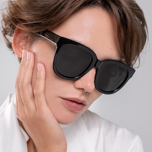 Black statement sunglasses designed for medium face shapes