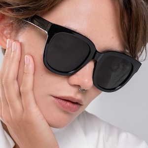 Large black sunglasses designed for comfortable everyday wear and sun protection
