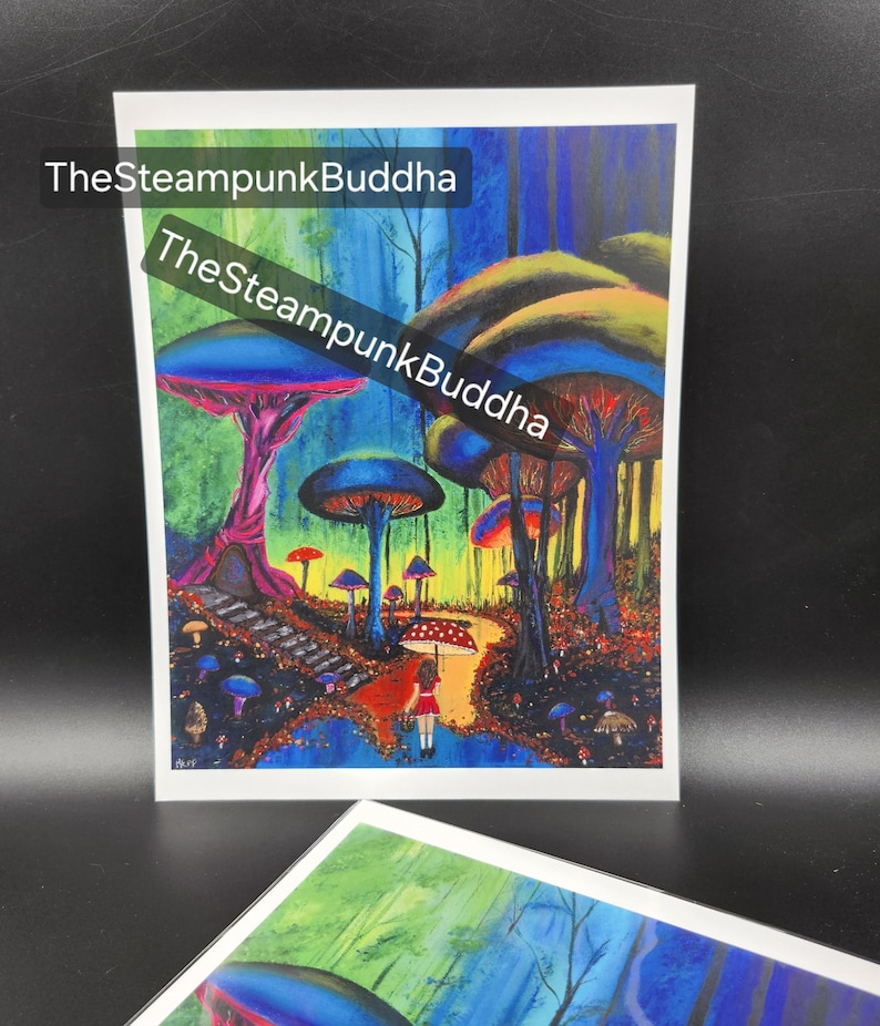 May include: A colorful fantasy art print featuring a whimsical mushroom forest with a path and a figure with an umbrella. The artwork has vibrant blues, greens, reds, and purples. Text on the print reads "TheSteampunkBuddha".