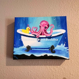 May include: A whimsical painting depicts a pink octopus in a white bathtub with black claw feet. A yellow rubber duck floats nearby. The background is blue with water droplets, creating a playful, aquatic scene. The artwork is signed.