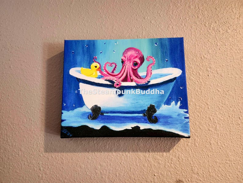 May include: A whimsical painting depicts a pink octopus in a white bathtub with black claw feet. A yellow rubber duck floats nearby. The background is blue with water droplets, creating a playful, aquatic scene. The artwork is signed.