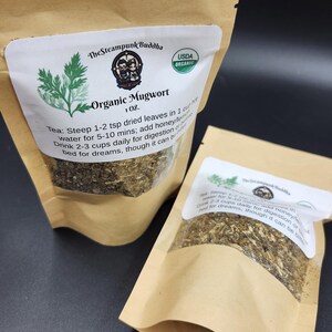 May include: Two brown paper bags of Organic Mugwort tea. Each bag has a white label with the text "The Steampunk Buddha" and "USDA Organic". The label also includes instructions for steeping the tea.