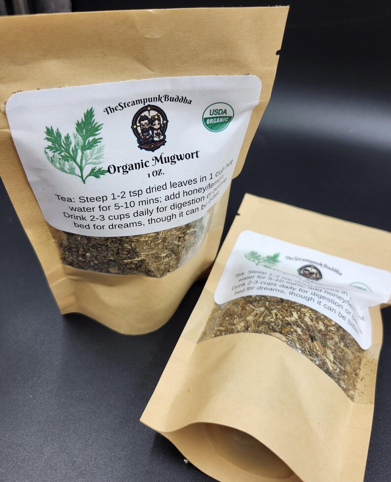 May include: Two brown paper bags of Organic Mugwort tea. Each bag has a white label with the text "The Steampunk Buddha" and "USDA Organic". The label also includes instructions for steeping the tea.
