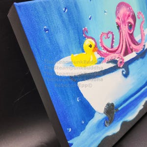 May include: A whimsical painting depicts a pink octopus in a white bathtub with a yellow rubber duck. The background is a gradient of blue, with water droplets and seahorse details. The artwork is on a canvas.