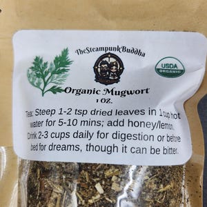 May include: A clear bag of organic mugwort tea. The label reads "The Steampunk Buddha" and "USDA Organic." Instructions are included: steep 1-2 tsp dried leaves in 1 cup hot water for 5-10 mins; add honey/lemon.